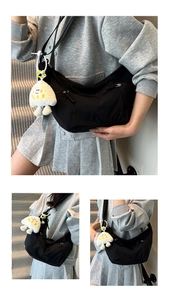 Detail of black nylon half-moon crossbody bag with adjustable strap and cute plush charm