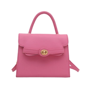 Pink faux leather trapezoid handbag with gold rotating metal buckle and top handle