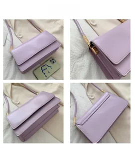 Detail view of light purple PU leather shoulder bag with gold buckles and layered interior