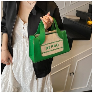 Detail of green and beige patchwork tote bag with embroidered BEPRO lettering decor