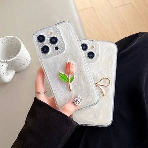 Elegant pearl white iPhone case featuring 3D pink tulip and gold bow decorations
