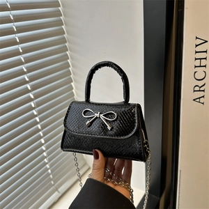 Snake pattern mini handbag with silver bow buckle and detachable chain strap in black