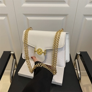 White faux leather baguette bag with floral embossing and gold chain shoulder strap