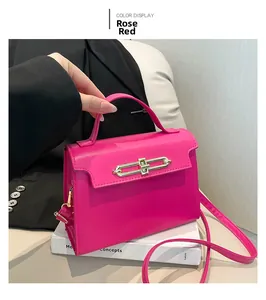 Detail of rose red PU leather handbag featuring elegant gold metal clasp and top handle