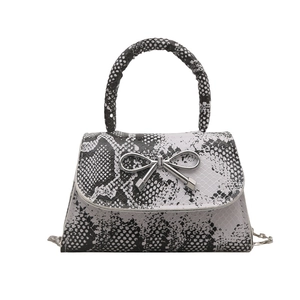 Fashionable snakeskin texture crossbody bag with silver bow detail and chain strap