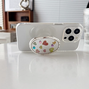 Motifs de cœurs scintillants sur support de téléphone ovale pour iPhone sur table