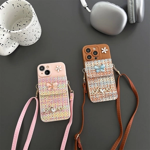 Detail of tweed crossbody phone case with floral butterfly card pocket and long shoulder strap