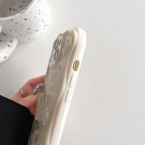 Detail of cream white 3D wavy phone case for iPhone with precise cutouts and aesthetic texture
