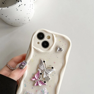 Detail of cream wavy iPhone case with silver butterflies and sparkly heart rhinestones