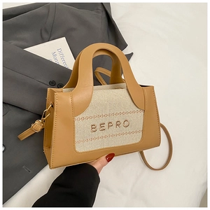 Close-up of contrast stitching fabric and leather textures on the BEPRO handbag