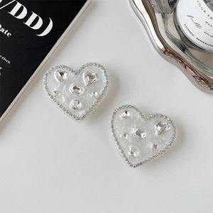 Macro detail of heart phone sockets with rhinestone inlay and pearl luster finish