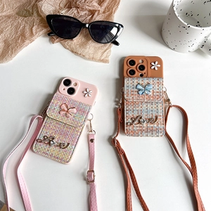 Tweed iPhone case with crossbody strap, butterfly pocket, and flower charm detail