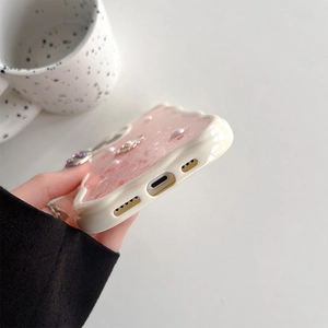 Dettaglio custodia rosa ondulata per telefono con glitter, perle e strass per iPhone