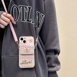 Close-up of pink iPhone case with tweed coin purse, floral accents and crossbody strap