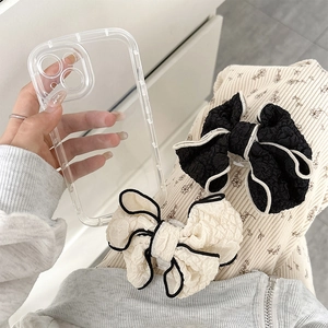 Detail of fabric bow phone socket on transparent case with soft bubble texture