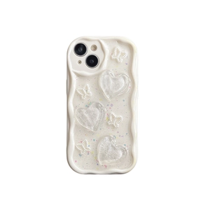 Creamy white wavy iPhone 16 Pro Max case with 3D hearts, pearls, and glitter details