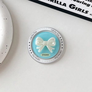 Close-up of a blue magnetic bow phone socket with pearls and Gift For You text