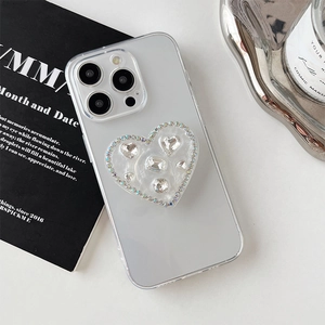 Detail of glitter heart rhinestone phone grip holder on a matte translucent case