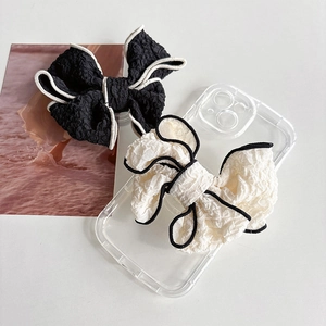 Minimalist fabric bow collapsible phone stand in black and off-white chic styles