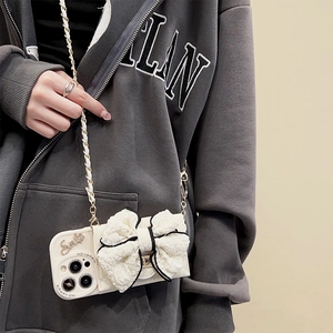 Creamy white iPhone case with large lace bow and woven gold chain crossbody strap