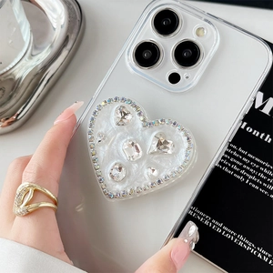 Close-up of sparkling heart-shaped phone grip with rhinestones and large crystals