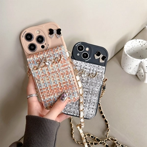 Detail of tweed pocket phone cases with rhinestone bow, metal Love text and chain strap