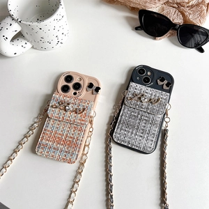 Detail of tweed iPhone case featuring rhinestone Love wallet pocket and braided strap
