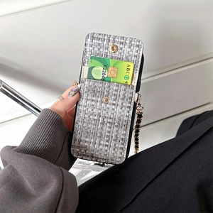 Close-up of grey tweed iPhone case featuring flip card slot and black-gold chain strap