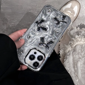 Silver glitter iPhone case with 3D black bow charms and rhinestones in handheld view
