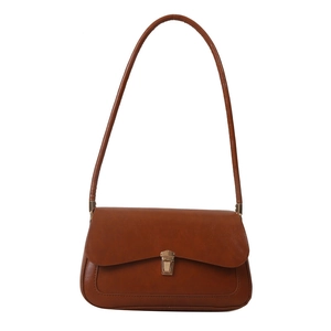 Classic caramel leather underarm bag with vintage metal buckle and minimalist design