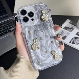 Detail of iPhone case with silver marble texture, 3D white roses and pearl decorations