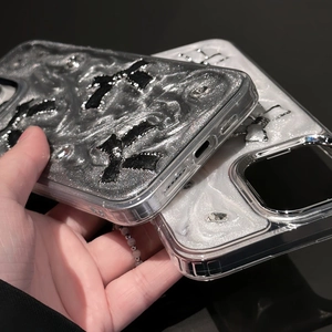 Detail of glitter phone case for iPhone featuring 3D bow design and protective metal camera frame