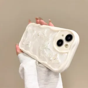 Detail of cream wave-frame iPhone case with 3D pearls and translucent butterfly decor