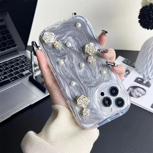 Floral iPhone case with 3D white roses, pearls, and silver marble pattern on a clear shell