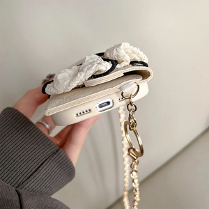 Detail of lychee pattern leather iPhone case with bow fabric and crossbody chain