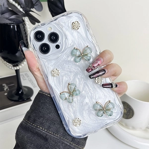 Detail of iPhone case with 3D butterflies and silver roses held by a model