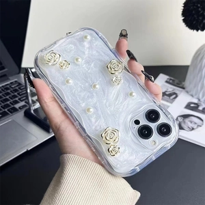 Detail showing 3D pearl decorations and gold-edged roses on the pearlescent phone case