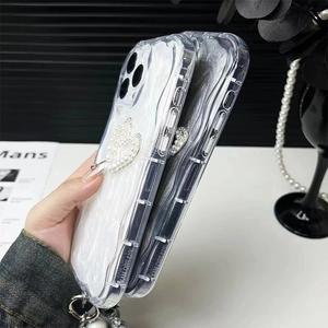 Detailed side view of wavy phone case for iPhone with pearl hearts and beaded handle