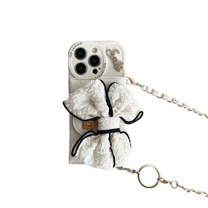 Crossbody iPhone case with large white 3D bow and elegant gold metal chain strap