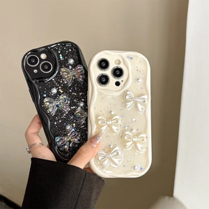 Handheld iPhone case with 3D pearlescent bows and glitter star sequins in black and cream