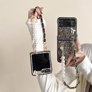 Close-up of black glitter phone case with pearl strap and bow detail for Z Flip5