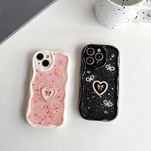 Glitzernde iPhone Hülle mit Perlenherz und Schleife in Rosa und Schwarz Design