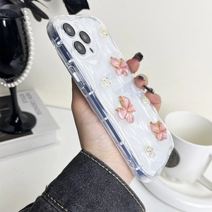 Detail of 3D pink butterflies and white roses on a pearlescent white iPhone case