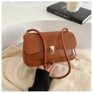 Vintage brown leather shoulder bag with gold metal clasp and minimalist French style