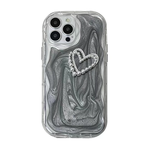 Gray marble iPhone case with large pearl heart decoration and protective clear frame