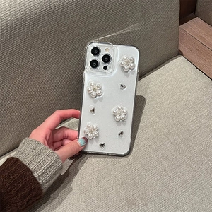 Dettaglio della custodia iPhone trasparente con fiori di perle e glitter argento