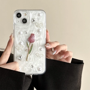 Détail de coque iPhone avec tulipe 3D, perles et nœud sur une surface nacrée brillante