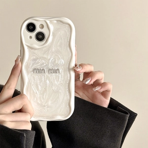 Macro shot of wavy pearl white iPhone case with glitter letter inlay and luxury texture