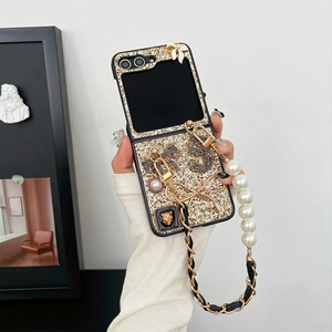 Detail of glitter phone case for Z Flip with pearl handle and 3D metallic charms