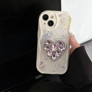 Detail of cream wave phone case with pink heart crystal, sequins and pearls for iPhone